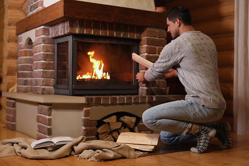 Guy warm and cosy by fire